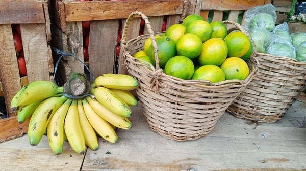 关闭香蕉 石灰和番石榴 没有种子的篮子陈列在市场上的木板上 — 图库照片