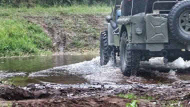 Düşük Açılı Manzara Koyu Yeşil Macera Arabası Ormanın ortasında bir nehrin kenarında