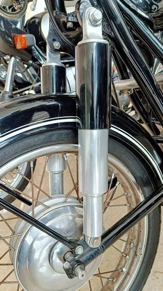 Close Up of Classic Motorcycle Front Suspension on spoke wheels