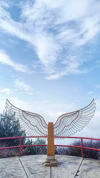 stock image Wing statue for tourism photo spot with blue sky and white clouds background