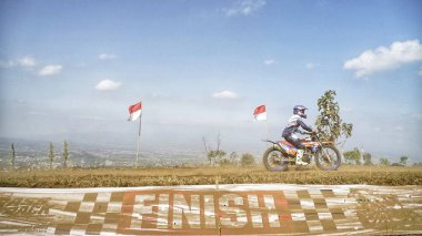 Batu City, East Java, Indonesia - August 31, 2024 : Motocross riders finish the race at the finish line area clipart