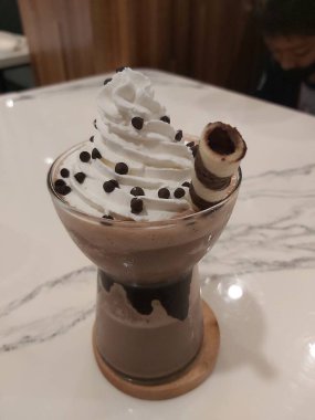 Mocha frappe in plastic cup. Served with whipping cream and chocolate sauce. Freshness drink. Favorite caffeine beverage menu.