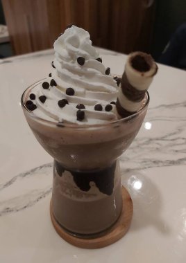 Mocha frappe in plastic cup. Served with whipping cream and chocolate sauce. Freshness drink. Favorite caffeine beverage menu.