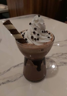 Mocha frappe in plastic cup. Served with whipping cream and chocolate sauce. Freshness drink. Favorite caffeine beverage menu.