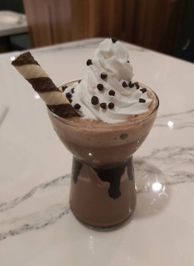 Mocha frappe in plastic cup. Served with whipping cream and chocolate sauce. Freshness drink. Favorite caffeine beverage menu.
