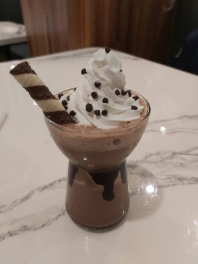 Mocha frappe in plastic cup. Served with whipping cream and chocolate sauce. Freshness drink. Favorite caffeine beverage menu.