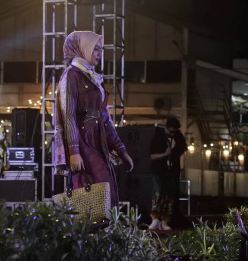 Jakarta, Indonesia - December 2022 :beautiful woman wearing an elegant batik dress, Batik is a fabric that is painted using canting and liquid wax night so as to form paintings of high artistic 