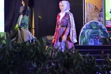 Jakarta, Indonesia - December 2022 :beautiful woman wearing an elegant batik dress, Batik is a fabric that is painted using canting and liquid wax night so as to form paintings of high artistic 