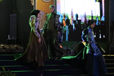 Jakarta, Indonesia - December 2022 :beautiful woman wearing an elegant batik dress, Batik is a fabric that is painted using canting and liquid wax night so as to form paintings of high artistic 