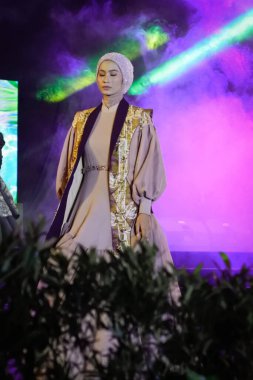 Jakarta, Indonesia - December 2022 :beautiful woman wearing an elegant batik dress, Batik is a fabric that is painted using canting and liquid wax night so as to form paintings of high artistic 