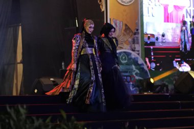 Jakarta, Indonesia - December 2022 :beautiful woman wearing an elegant batik dress, Batik is a fabric that is painted using canting and liquid wax night so as to form paintings of high artistic 