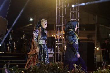 Jakarta, Indonesia - December 2022 :beautiful woman wearing an elegant batik dress, Batik is a fabric that is painted using canting and liquid wax night so as to form paintings of high artistic 