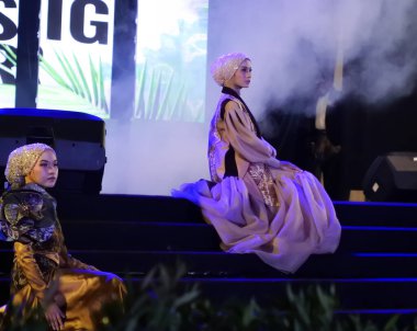 Jakarta, Indonesia - December 2022 :beautiful woman wearing an elegant batik dress, Batik is a fabric that is painted using canting and liquid wax night so as to form paintings of high artistic 