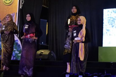 Jakarta, Indonesia - December 2022 : beautiful woman wearing an elegant batik dress, Batik is a fabric that is painted using canting and liquid wax night so as to form paintings of high artistic 