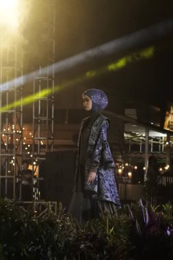 Jakarta, Indonesia - December 2022 : beautiful woman wearing an elegant batik dress, Batik is a fabric that is painted using canting and liquid wax night so as to form paintings of high artistic 