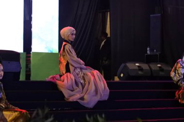 Jakarta, Indonesia - December 2022 : beautiful woman wearing an elegant batik dress, Batik is a fabric that is painted using canting and liquid wax night so as to form paintings of high artistic 