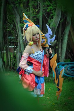 Jakarta, Indonesia - October 29, 2022: Cosplayer girl dressed character from the fantasy video game Genshin Impact Yoimiya at cosplay event.