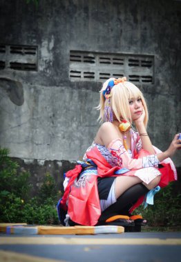 Jakarta, Indonesia - October 29, 2022: Cosplayer girl dressed character from the fantasy video game Genshin Impact Yoimiya at cosplay event.