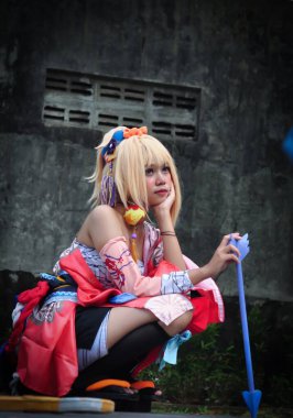 Jakarta, Indonesia - October 29, 2022: Cosplayer girl dressed character from the fantasy video game Genshin Impact Yoimiya at cosplay event.