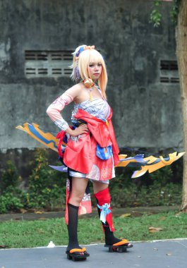 Jakarta, Indonesia - October 29, 2022: Cosplayer girl dressed character from the fantasy video game Genshin Impact Yoimiya at cosplay event.