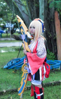 Jakarta, Indonesia - October 29, 2022: Cosplayer girl dressed character from the fantasy video game Genshin Impact Yoimiya at cosplay event.