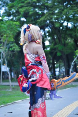 Jakarta, Indonesia - October 29, 2022: Cosplayer girl dressed character from the fantasy video game Genshin Impact Yoimiya at cosplay event.