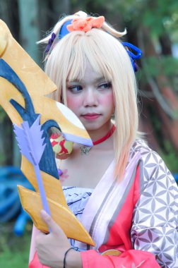 Jakarta, Indonesia - October 29, 2022: Cosplayer girl dressed character from the fantasy video game Genshin Impact Yoimiya at cosplay event.