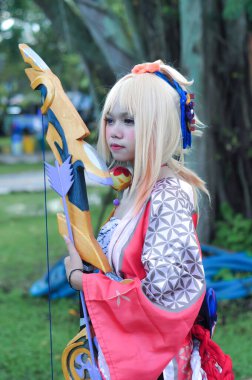 Jakarta, Indonesia - October 29, 2022: Cosplayer girl dressed character from the fantasy video game Genshin Impact Yoimiya at cosplay event.