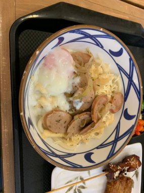 Japon yemeği. Lezzetli aromalı et ya da tempura ile servis edilen, taze soğan ve yumurta sunan Carbonara Curry Udon Marugame Kalın udon eriştesi..