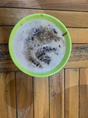 Yeşil fasulye lapası ve hindistan cevizi sütlü siyah pirinç ve yeşil kase ile yapılan geleneksel Endonezya tatlısı.