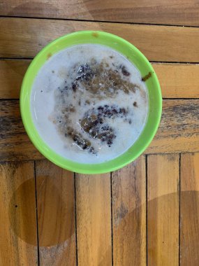 Yeşil fasulye lapası ve hindistan cevizi sütlü siyah pirinç ve yeşil kase ile yapılan geleneksel Endonezya tatlısı.