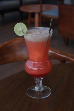 Kahverengi masada limon meyveli alkolsüz taze kokteyl. Kahve dükkanının dışındaki yazlık taze içecekler.