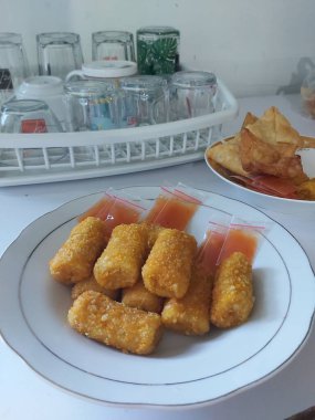 Risoles Rogout, Endonezya 'nın geleneksel lezzetli atıştırmalıkları. Tavuk pirzolası, sebze ve kızartma ile dolu. Kırmızı biberli beyaz tabakta servis ediliyor. Seçici odak.