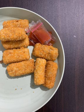 Risoles Rogout, Indonesian traditional savory snack. Filled with chicken chopped and mix vegetable and deep fried. Served in white plate with chilli. Selective focus. clipart