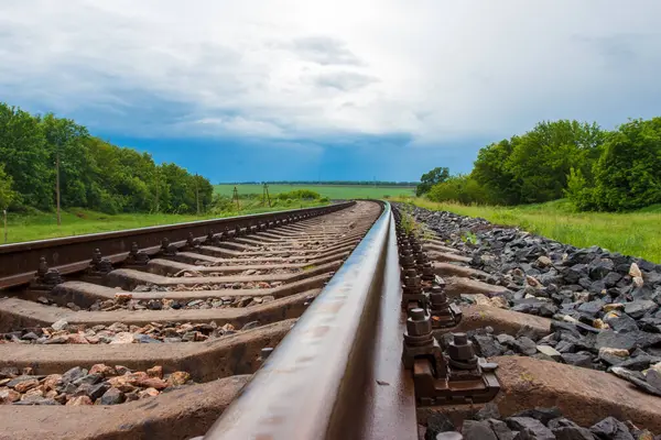 stock image Rails on the electrified railway corridor. Rails amidst the cloudy sky. The railway passing on the nature