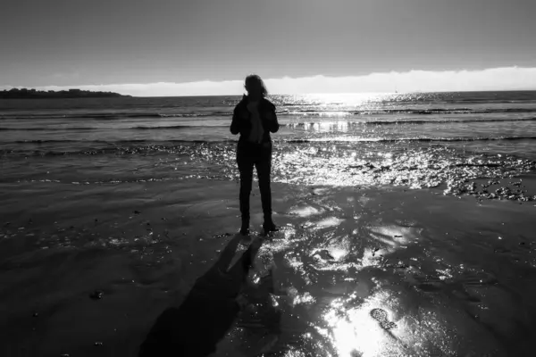 full-length and backlight portrait of a woman on the beach at Royan.