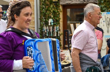 Montignac-Lascaux, France - July 2, 2023 : view of an accordionist during 102nd felibree parade. clipart