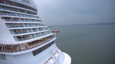 Surabaya, East Java, Indonesia - December 20, 2022 : Genting Dream Cruise Ship at Tanjung Perak Harbor, Surabaya. the tourists are very happy to travel around the city. the ship ready to depart