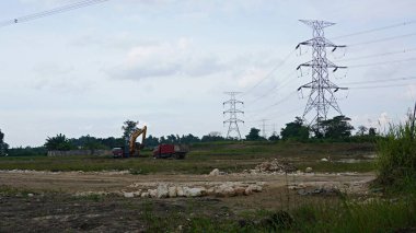 Landscape clouds sky above electric tower and electric power station at rural village. overcast weather climate change   