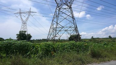 Landscape clouds sky above electric tower and electric power station at rural village. overcast weather climate change   