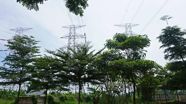 Landscape clouds sky above electric tower and electric power station at rural village. overcast weather climate change