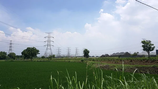 Landscape clouds sky above electric tower and electric power station at rural village. overcast weather climate change