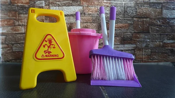 Children\'s games cleaning tools toy with warning wet signs as a means of educational games
