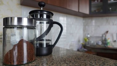 Selective focus concepts and ideas coffee cups, coffee powder in glass bottles and coffee pot in the kitchen bar counter      