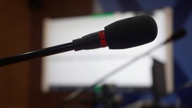Selective focus concept and idea of a table mic microphone in a meeting room for business meeting seminars and teleconferences            
