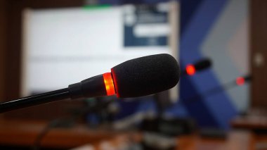 Selective focus concept and idea of a table mic microphone in a meeting room for business meeting seminars and teleconferences            