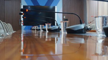 Selective focus concept and idea of a table mic microphone in a meeting room for business meeting seminars and teleconferences            