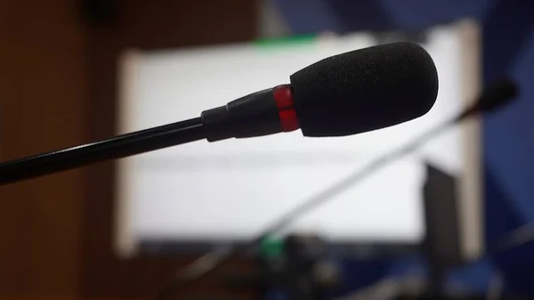 Selective focus concept and idea of a table mic microphone in a meeting room for business meeting seminars and teleconferences