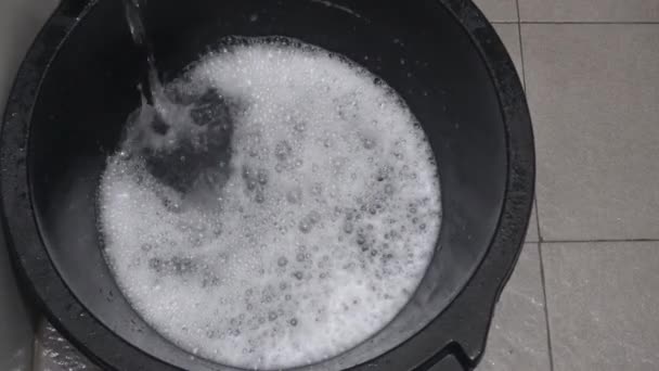 Water Flowing Faucet Laundry Detergent Makes Foam Bucket Preparation Washing — Stockvideo