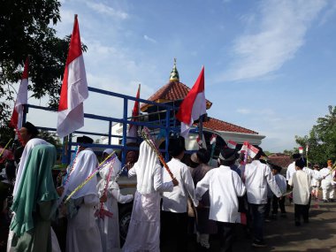 Surabaya, East Java, Indonesia - February, 2023 : Selective focus Elementary school children's parade in commemoration of the Prophet Muhammad's Isra and Miraj